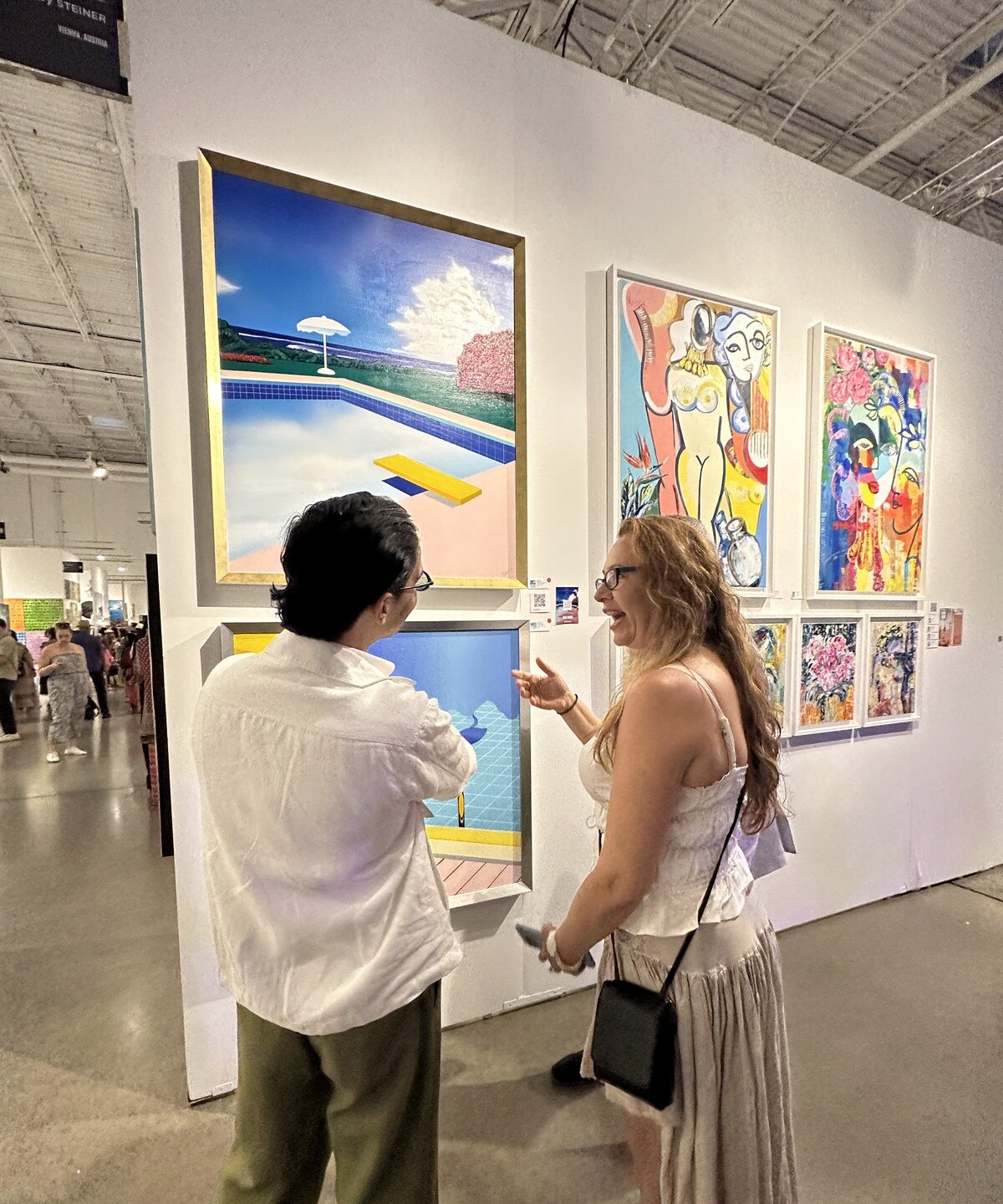 Two visitors talking in front of Skydive at Red Dot Miami 2025